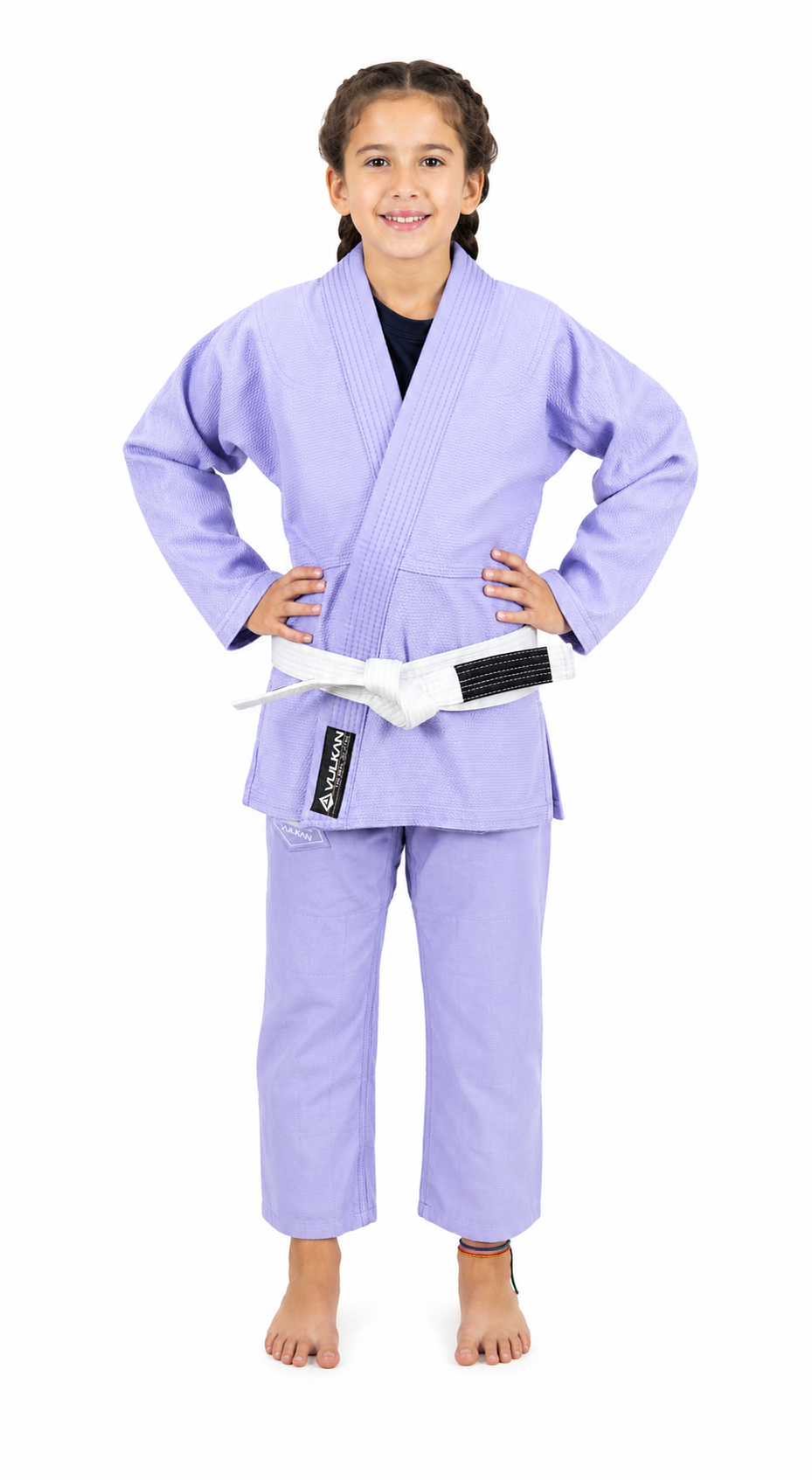 A young girl modeling a Vulkan light purple Brazilian Jiu-Jitsu gi with a white belt, standing against a plain white background.